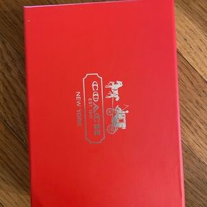 brand new beige and orange coach wristlet. Never worn